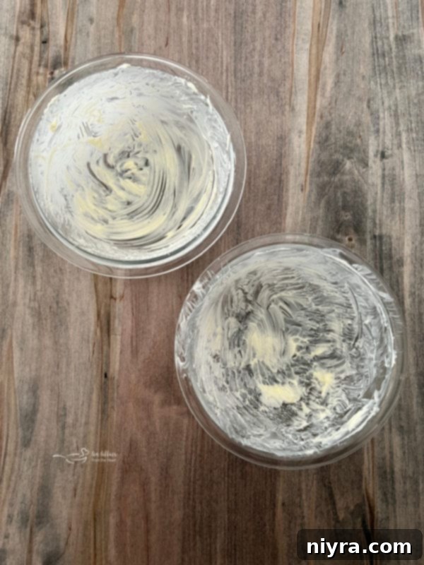 two greased bowls with butter