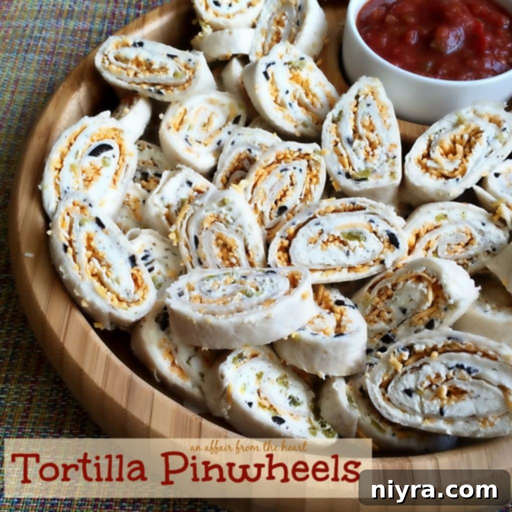 Delicious Creamy Green Chile and Olive Tortilla Pinwheels arranged on a serving platter, perfect for parties and game day