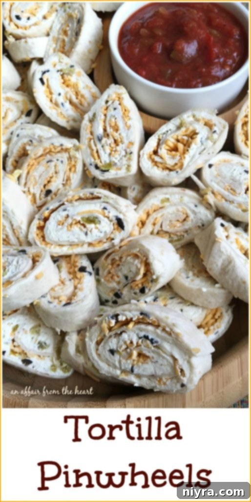Serving platter filled with an assortment of Creamy Green Chile and Olive Tortilla Pinwheels, garnished and ready to serve at a party