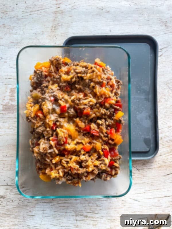 A vibrant image of the Stuffed Pepper Skillet, showcasing all the ingredients and a serving spoon, perfect for pinning on Pinterest.