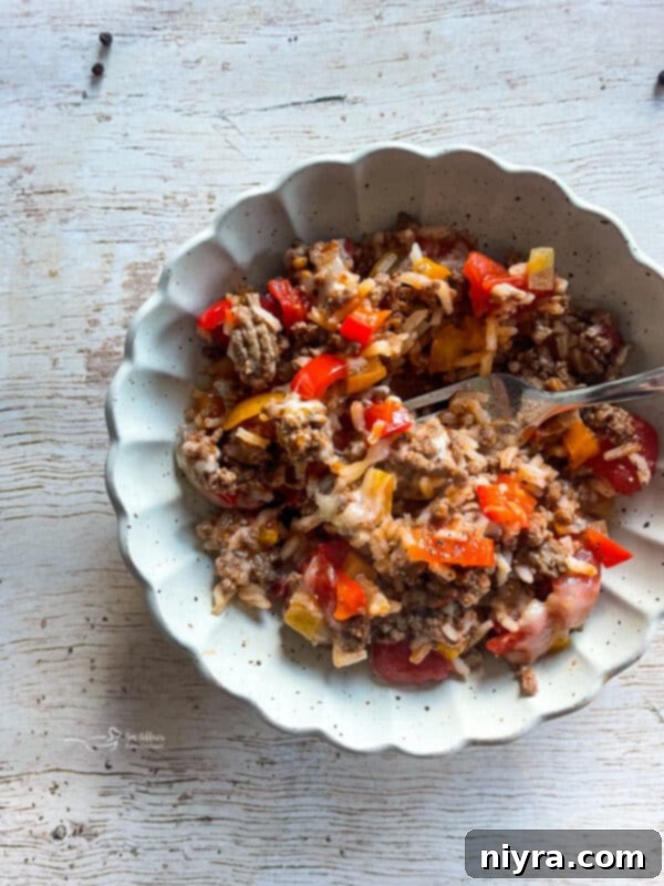 A close-up shot of the Stuffed Pepper Skillet in a cast iron pan, showing the rich texture and steam, emphasizing its deliciousness.