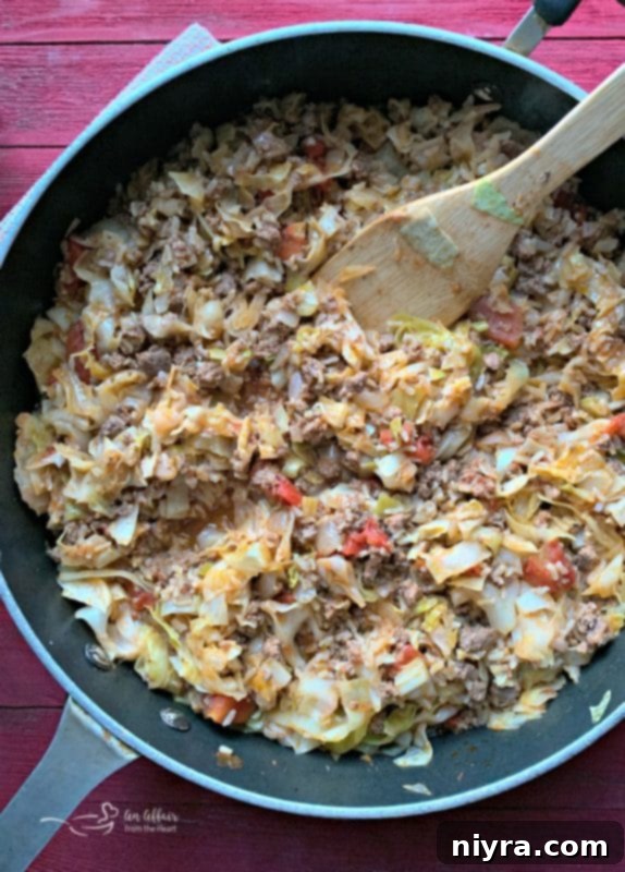 Unstuffed Cabbage Roll Skillet in a rustic pan, garnished with fresh herbs, showcasing a delicious one-pot meal.