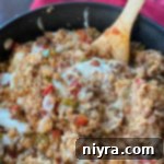 Stirring the cheese into Stuffed pepper skillet