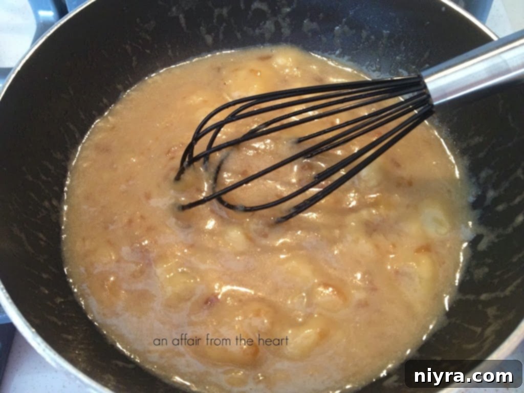 Preparing the Kahlua caramelized bananas in a skillet