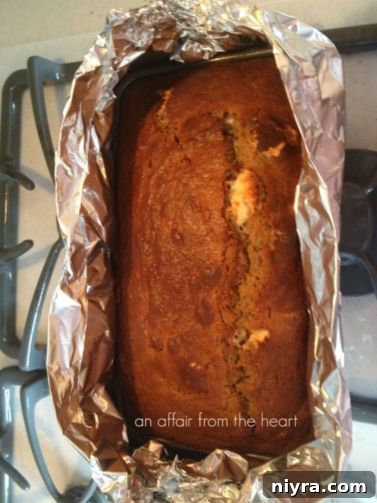 A slice of S'mores Banana Bread on a white plate, showing the moist interior