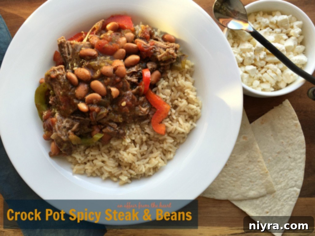 Hearty Crock Pot Spicy Steak & Beans served over rice