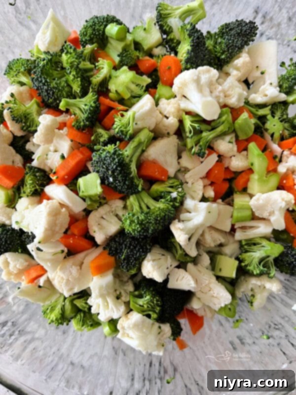 Pegs Fresh Italian Vegetable Salad 6 Raw cauliflower, broccoli, and carrots chopped in a large mixing bowl