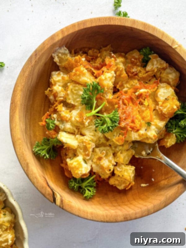 Cheesy Hash Brown Potato Casserole Served In A Bowl with a golden crust