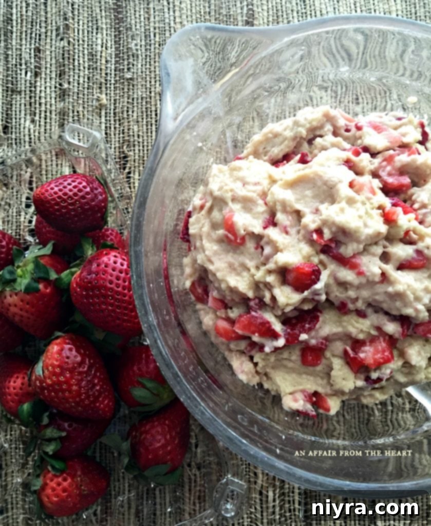 Side view of Strawberry Cheesecake Muffins on a cooling rack, showcasing their texture