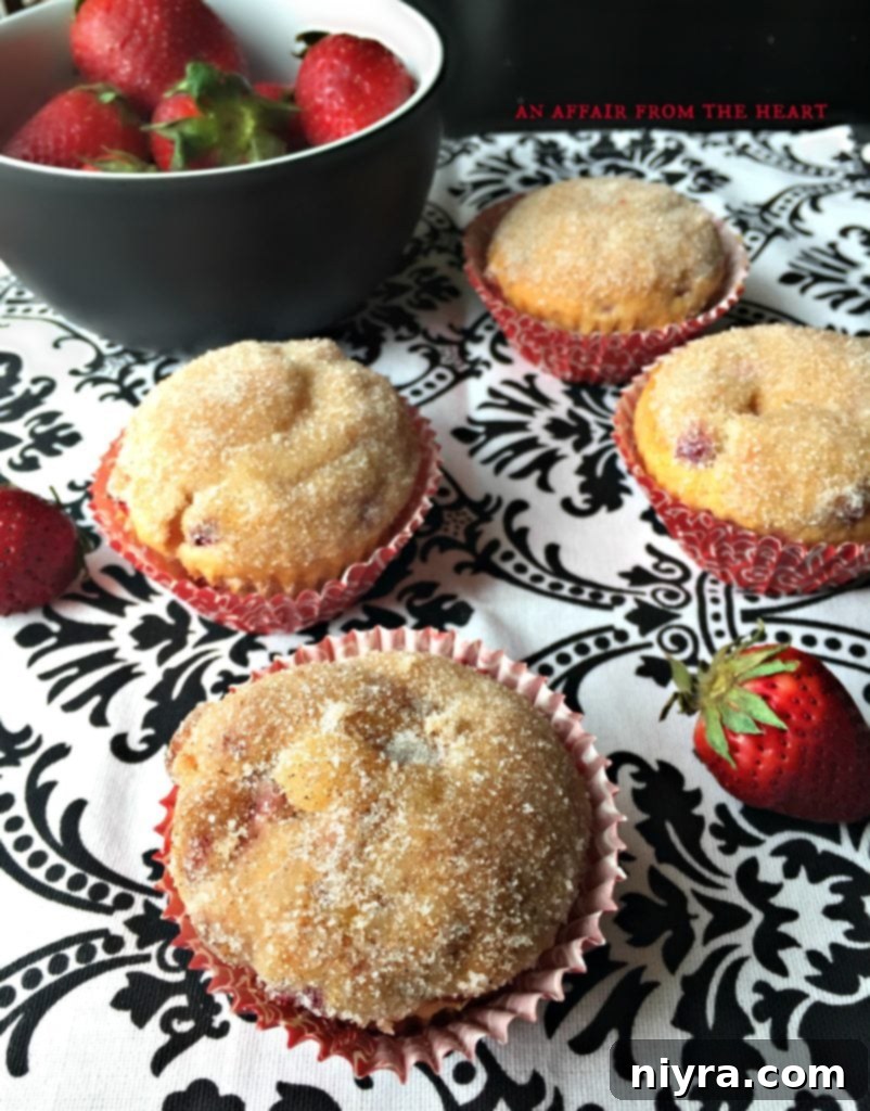 Tray of golden baked muffins, some topped with cinnamon sugar, ready to be served