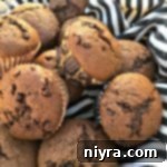 Freshly baked double chocolate banana muffins on a napkin, ready to be enjoyed.