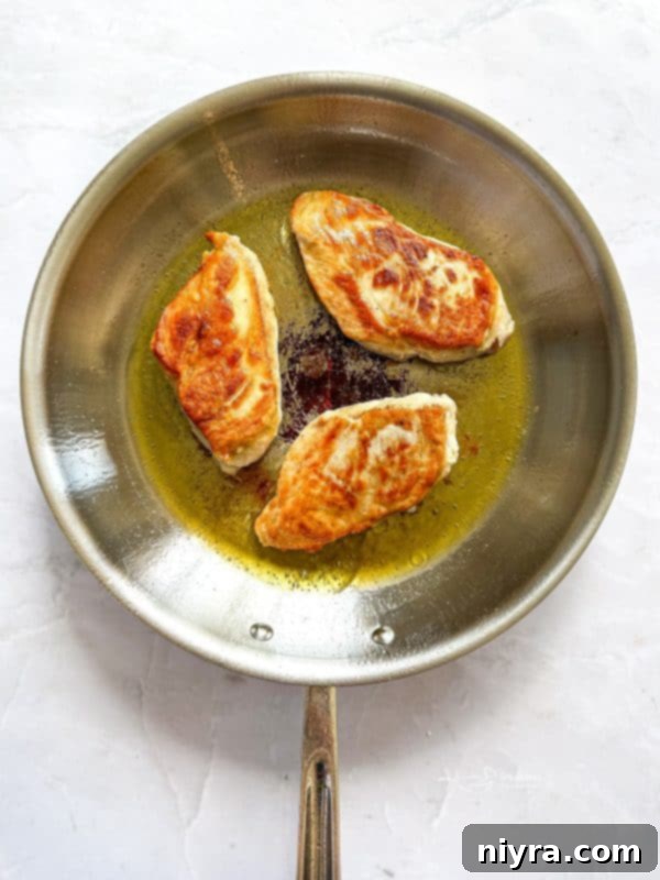 Chicken searing in a skillet