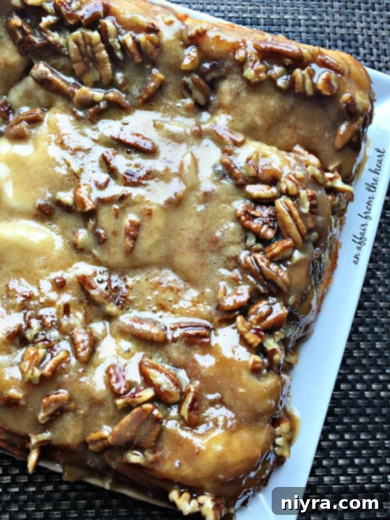 A plate of freshly baked Ice Cream Sticky Rolls with caramel sauce and pecans