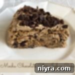 Mocha Chocolate Chip Icebox Delight 16 side view of a slice of cake on a white plate with text 'Mocha Chocolate Chip Icebox Cake'