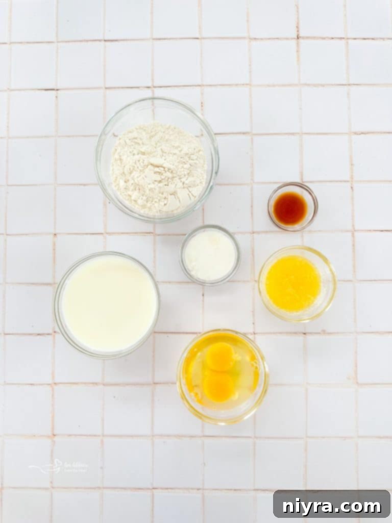 Individual ingredients for sweet crepes laid out on a wooden board: flour, sugar, eggs, milk, butter, and vanilla extract.
