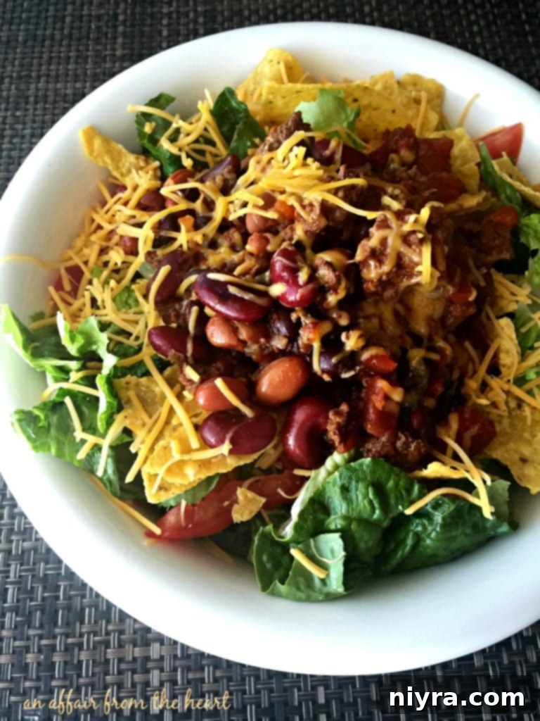 Close-up of a delicious Copycat Wendy's Original Taco Salad, showcasing the warm chili and fresh toppings