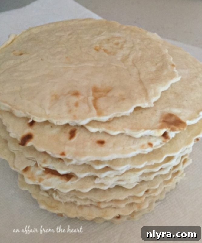 Stack of small, round flour tortillas, perfectly cut and ready to be transformed into dessert taco shells.