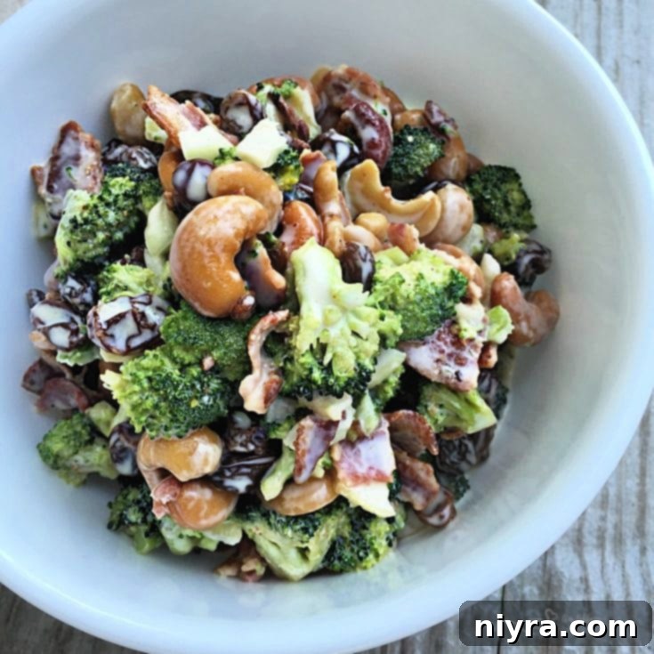 Top view bacon cashew broccoli salad in white bowl