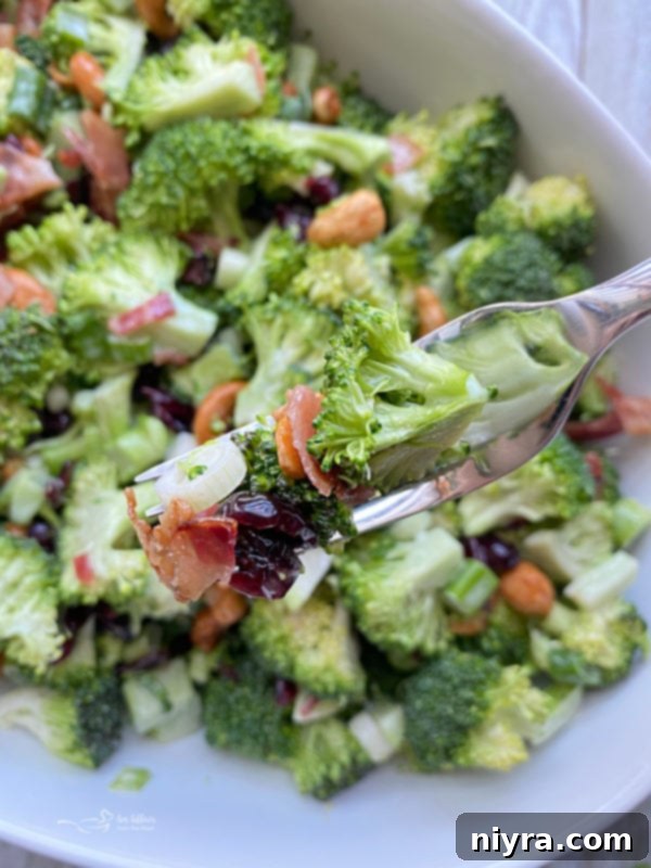 One bowl filled with bacon cashew broccoli salad