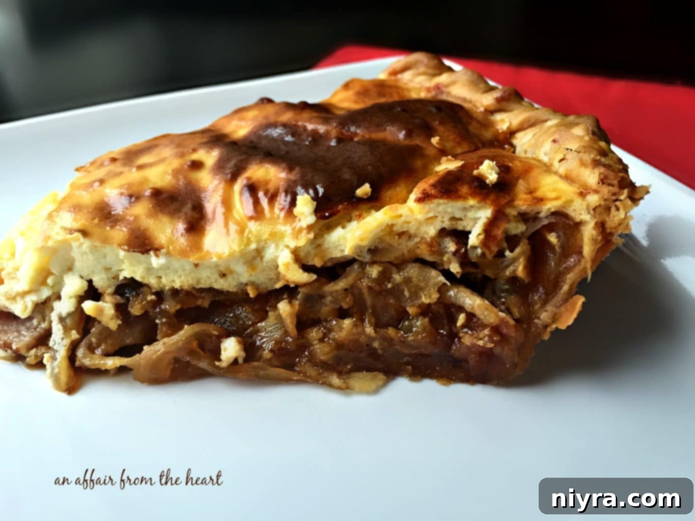 German Onion Tart 10 Slices of Zwiebelkuchen presented on a plate, revealing the layers of onions, bacon, and custard.