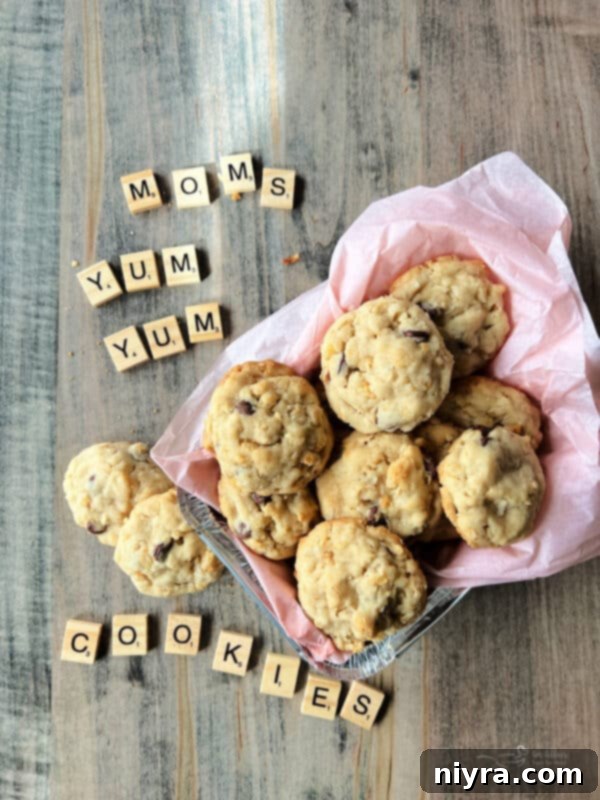 Mom's Yum Yum Cookies spelled out in wooden tiles with a bowl full of cookies next to them.