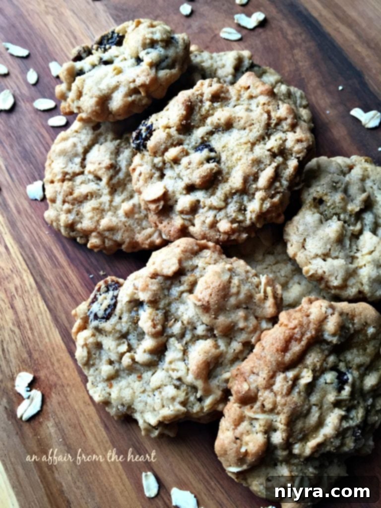 Grandma Jane's Oatmeal Raisin Cookies on a rustic wooden surface, inviting you to take a bite.