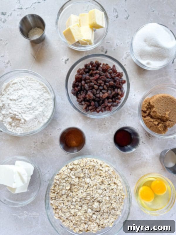 A close up of raw oatmeal raisin cookie dough on a baking sheet, ready for the oven.
