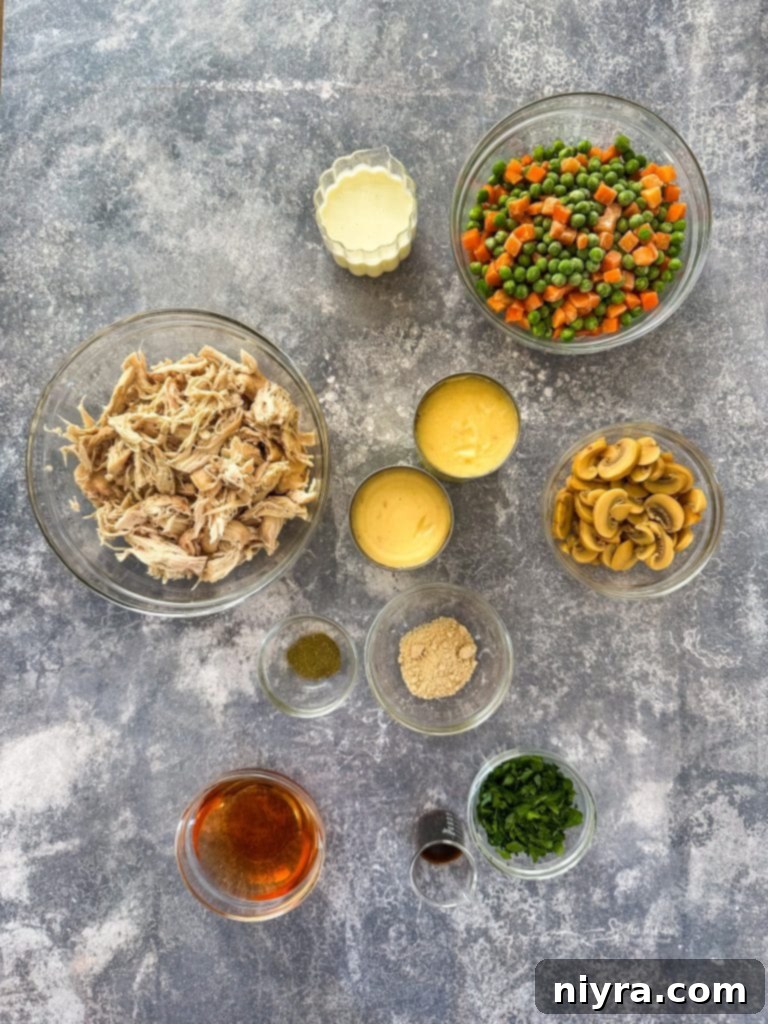 Regal Creamy Chicken Delight 4 Large bowl of Chicken à la King with a spoon, surrounded by fresh parsley and small bowls of ingredients.