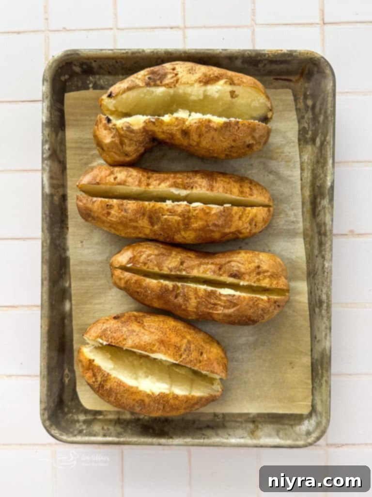 A whole, perfectly baked potato, ready to be stuffed.