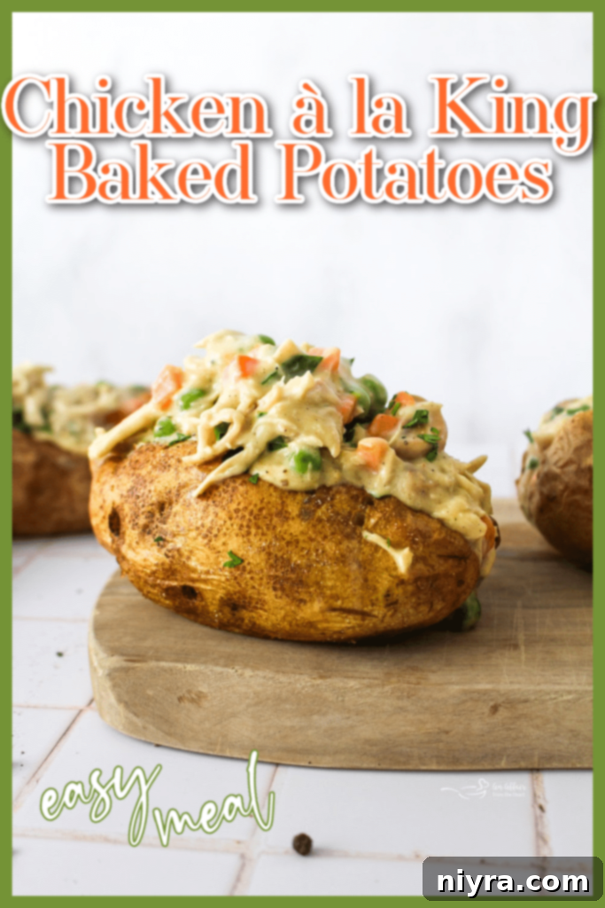 A beautifully presented Chicken à la King Baked Potato on a plate.