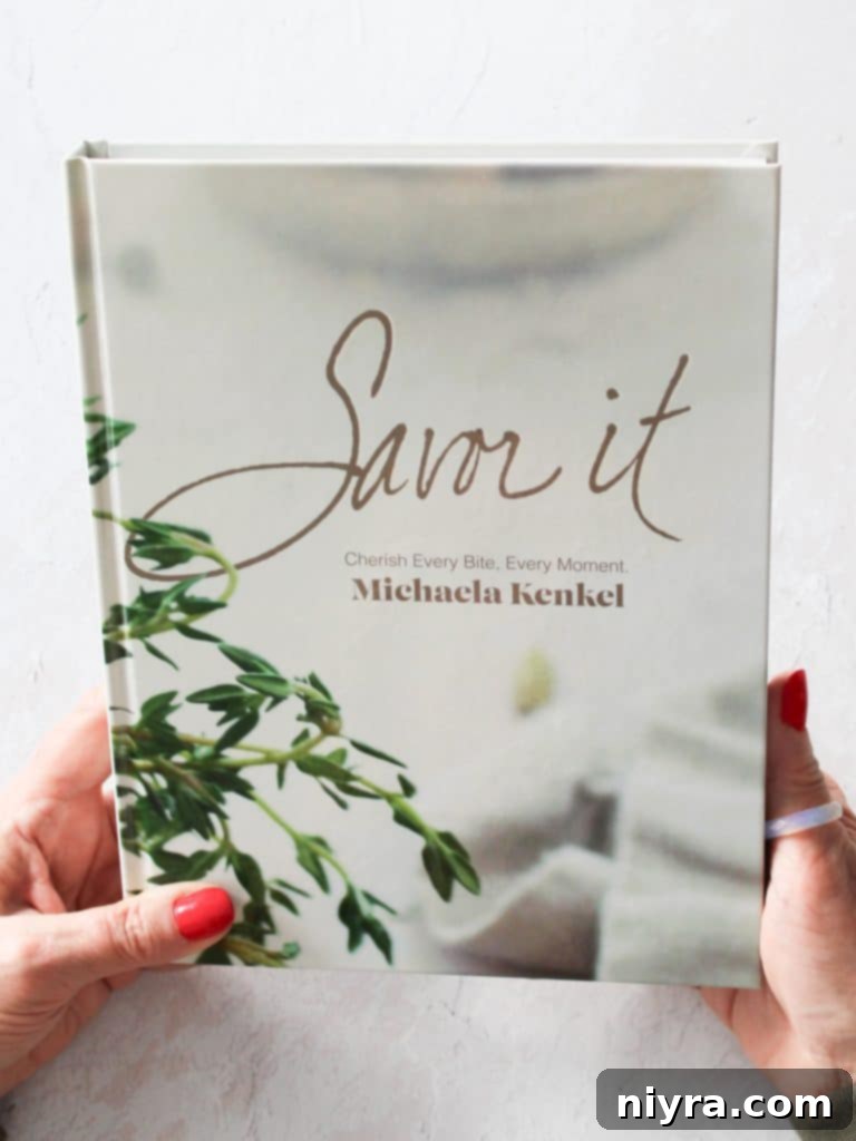 Ultimate Slow Cooker Chicken Enchilada Soup 3 Savor It Cookbook by Michaela Kenkel displayed open on a table.