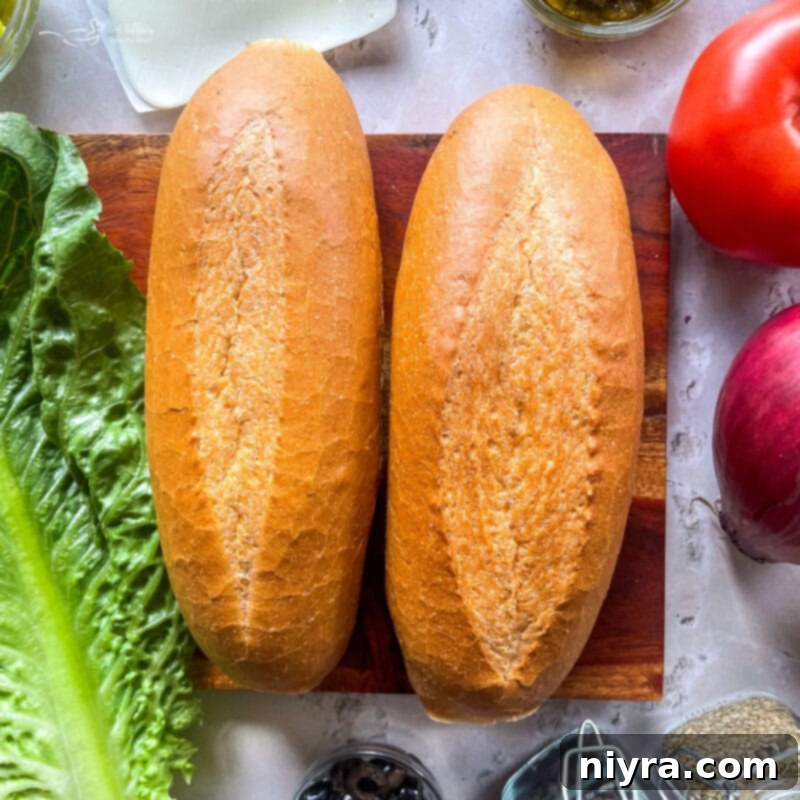 Hoagie buns ready with uncut toppings nearby