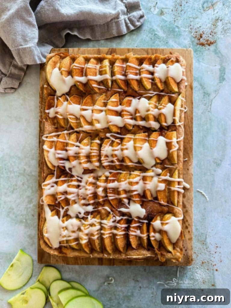 Drizzling vanilla glaze over the baked Apple Kuchen