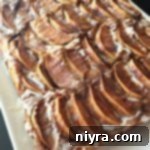 Apple Kuchen (German Apple Cake) on a white serving plate