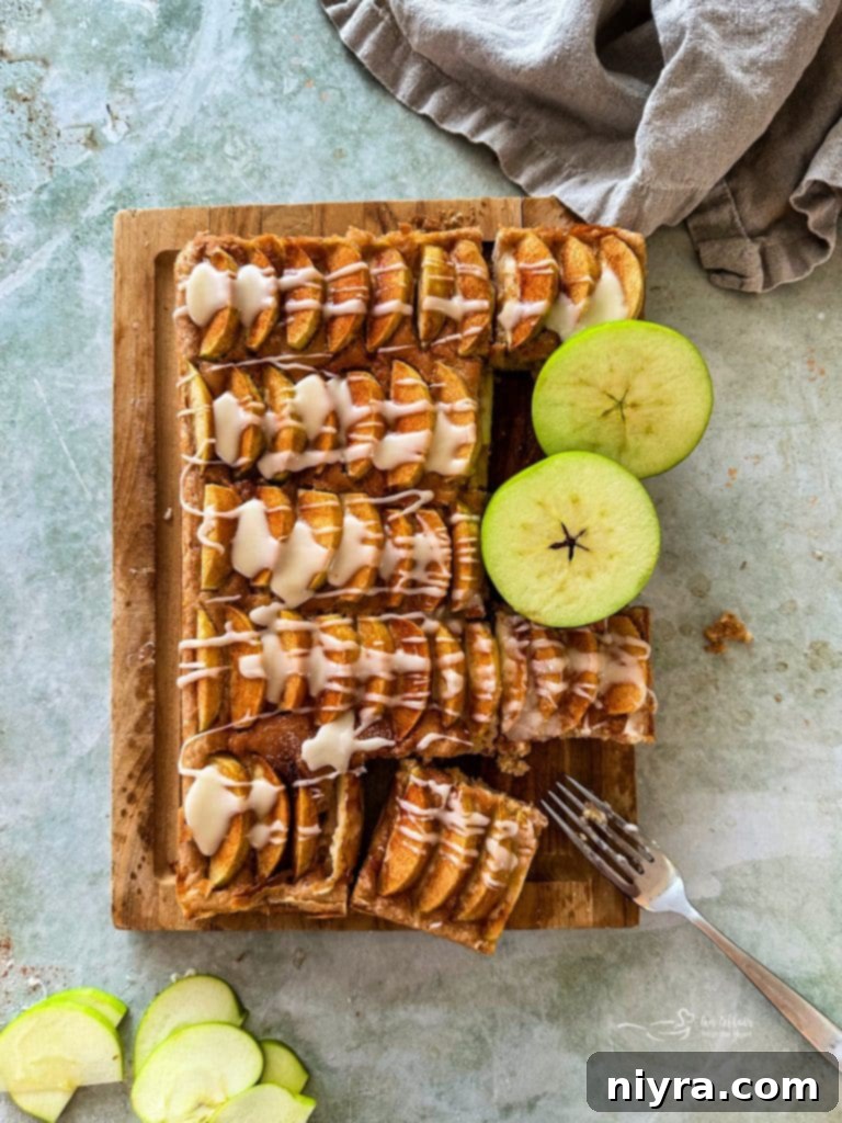 Close-up of a slice of Apple Kuchen showing the apple layers and cake base