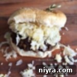 close up of a Brat Burger on a table