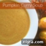 Close up of soup in a white bowl with text "Pumpkin Curry Soup"