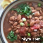 overhead of Southwestern Pinto Bean Soup in a white bowl