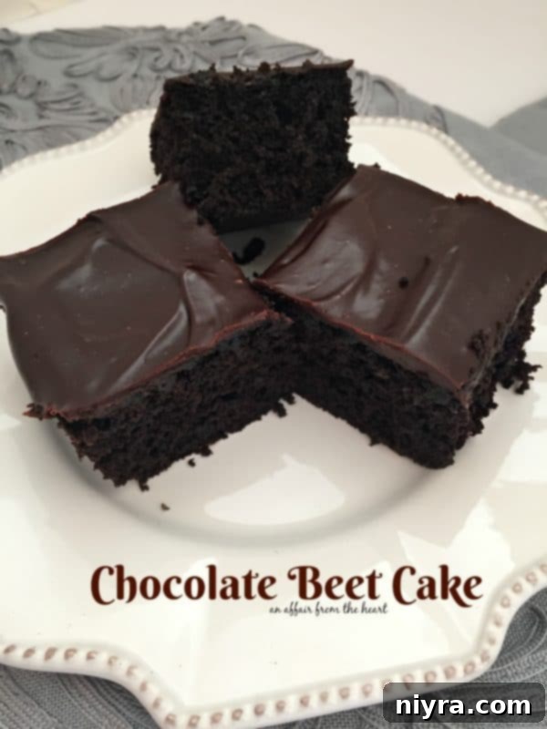 Decadent slice of Chocolate Beet Cake, rich and moist, with a thick layer of chocolate ganache