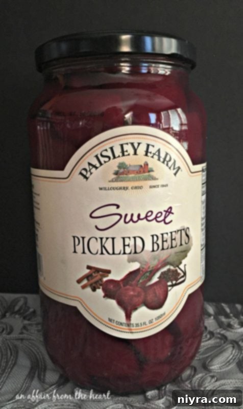 Beautifully sliced portion of Sweet Pickled Beet Chocolate Cake, highlighting its vibrant color and ganache topping