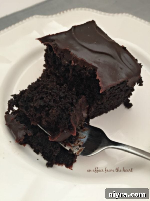 Close-up of a slice of Chocolate Beet Cake, showing the rich ganache and moist interior