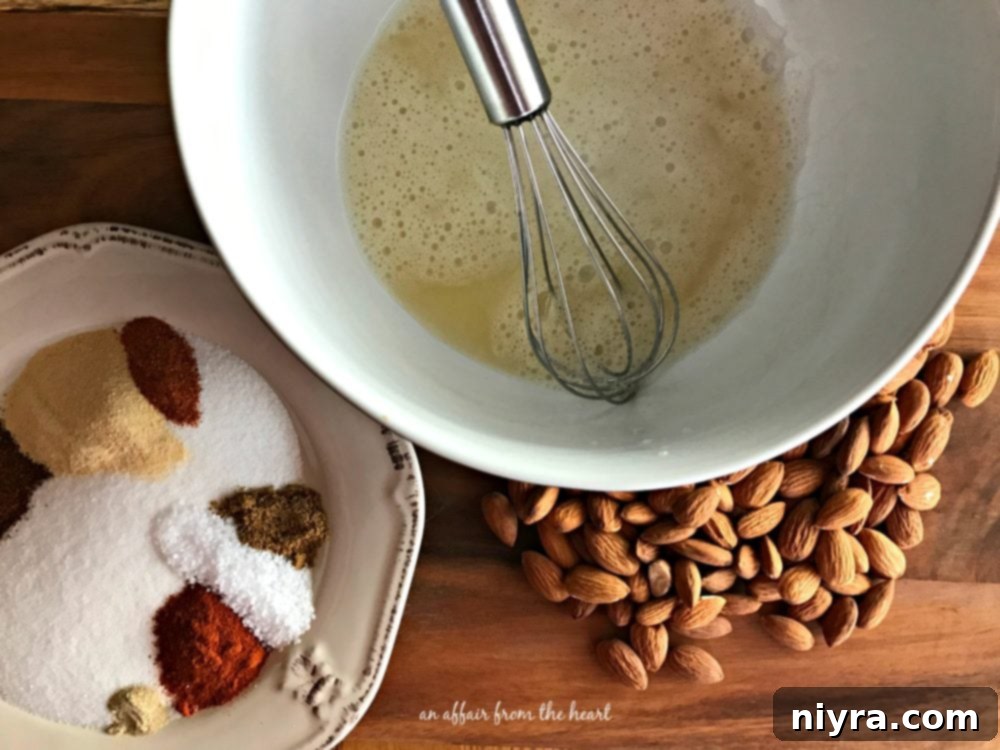 Smoky Heat Almonds 6 Egg white being whisked with water for the almond coating.