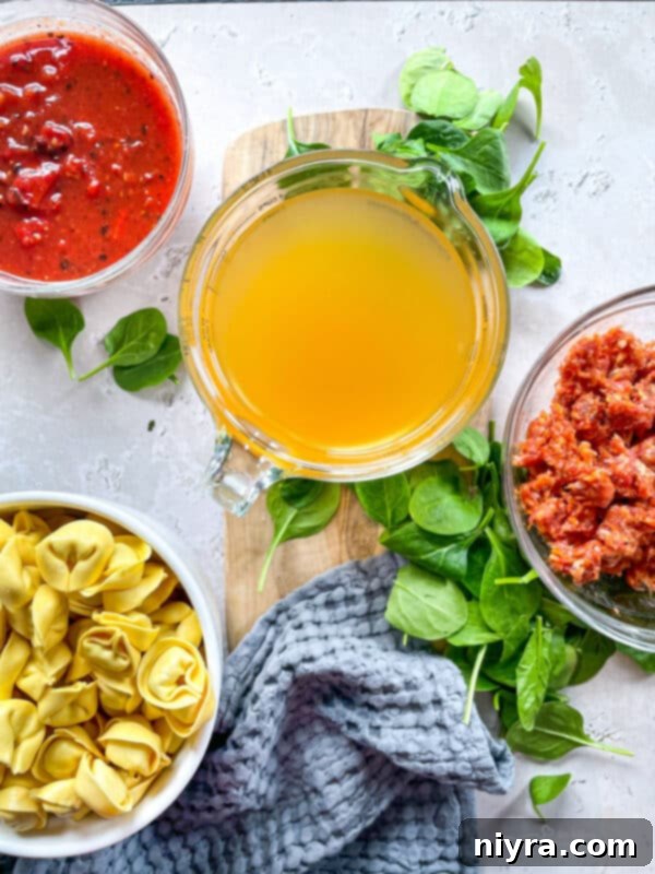 A serving of homemade Tortellini Soup with Sausage and Spinach.