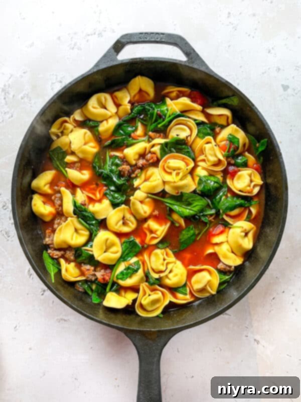 Step 3: Adding cheese tortellini to the simmering soup.