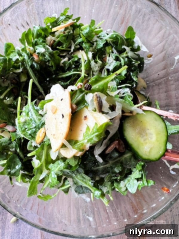 A vibrant close-up of the Sauerkraut Arugula Salad with a fork, ready to be eaten.