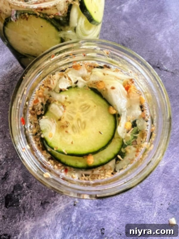 A single jar of sweet and spicy refrigerator pickles, beautifully presented