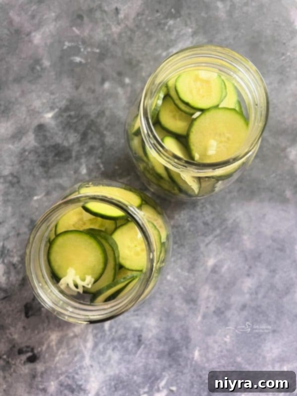 First step: Slicing cucumbers and onions on a cutting board