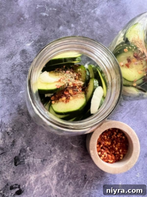 Third step: Pouring hot brine over sliced cucumbers and onions in a jar