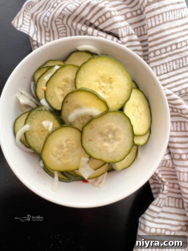 Close-up of a jar of refrigerator pickles with a fork, ready to be eaten
