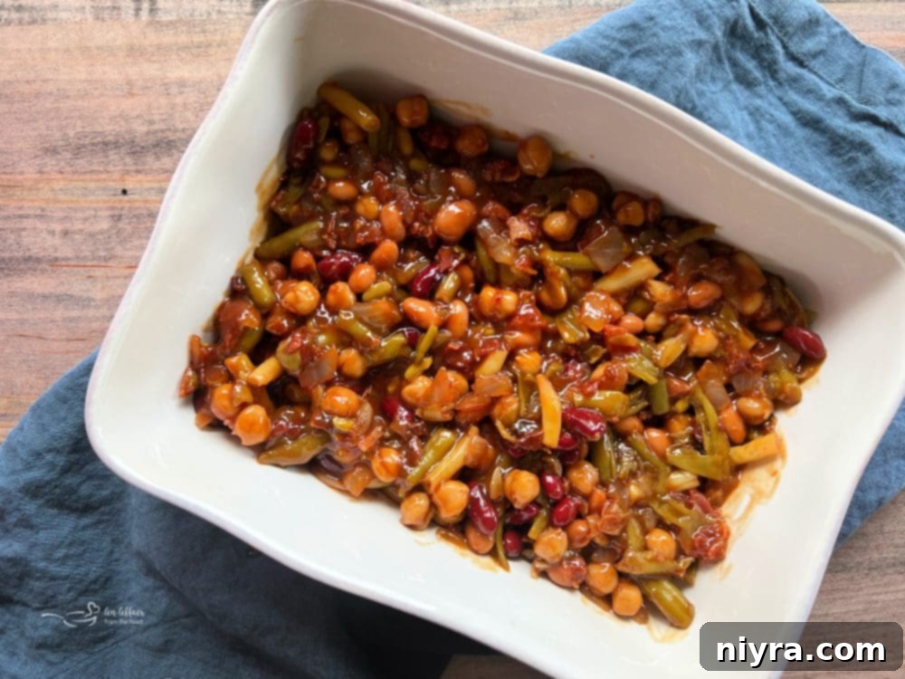 All the ingredients for the Five Bean Baked Beans being mixed together in a bowl.